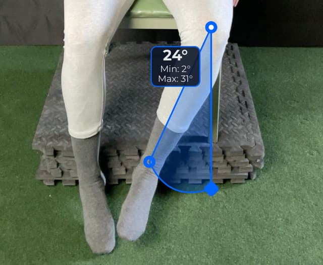 Front view of patient, sitting on a table, demonstrating the internal rotation/external rotation movement. Visual overlay shows a 24 degree angle measurement.