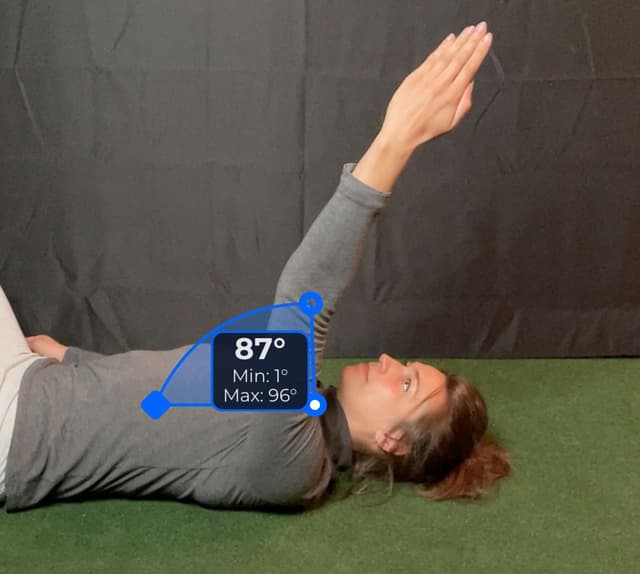 Side view of patient, supine, demonstrating the flexion/extension movement. Visual overlay shows an 87 degree angle measurement.